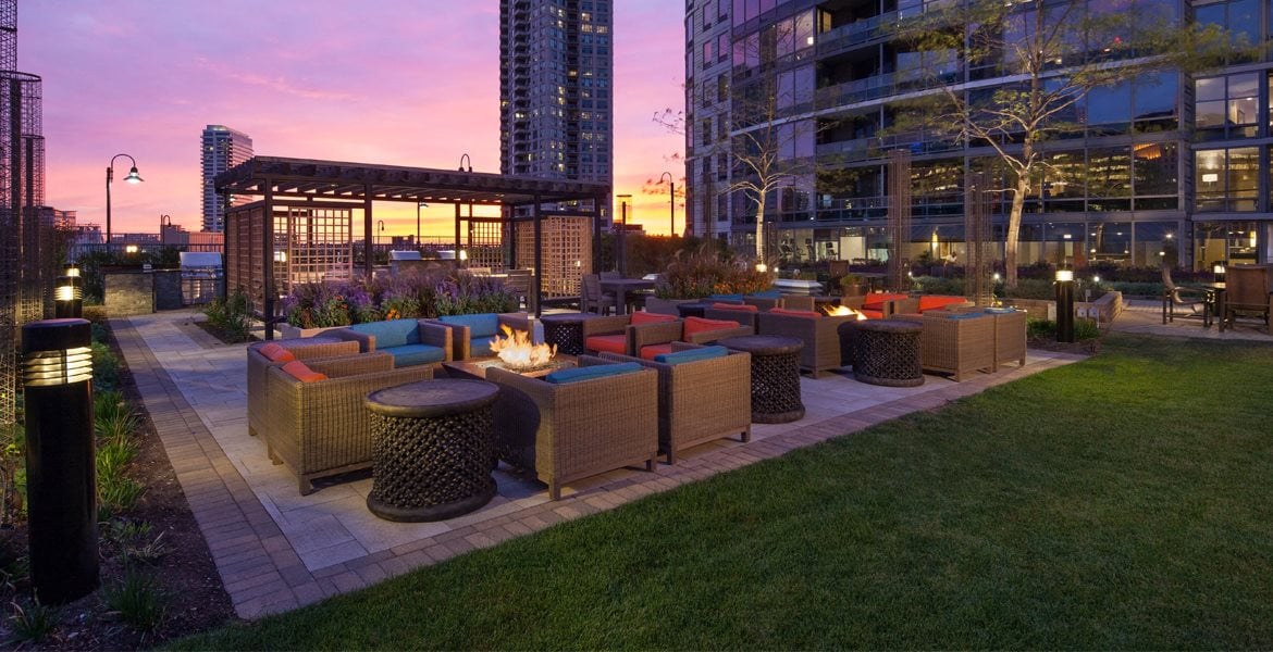 Outdoor fire pits, seating area, and gazebo at sunset